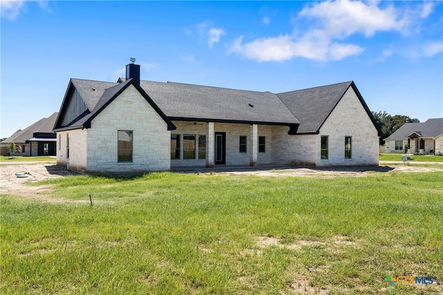 rear view of house with a lawn