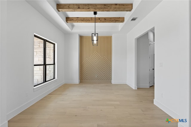 hall with light wood-type flooring and beam ceiling