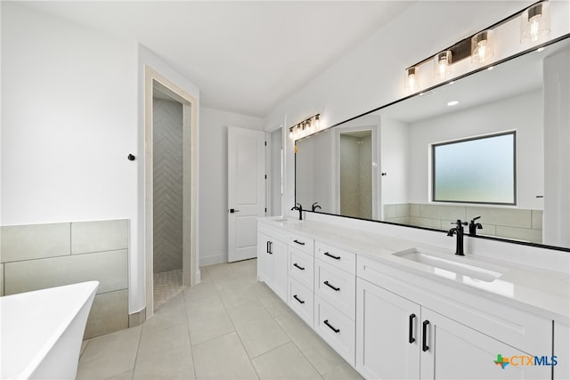 bathroom featuring shower with separate bathtub, vanity, and tile patterned floors