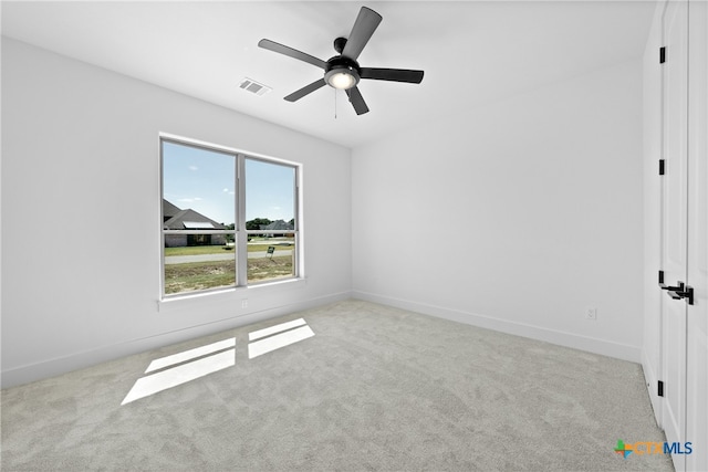 carpeted spare room featuring ceiling fan