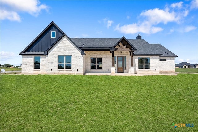 back of house with a lawn and a patio