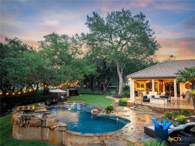9807 Klein Ct, New Braunfels, TX 78132 - pool at dusk featuring an outdoor hangout area, a patio area, a pool with connected hot tub, and a lawn
