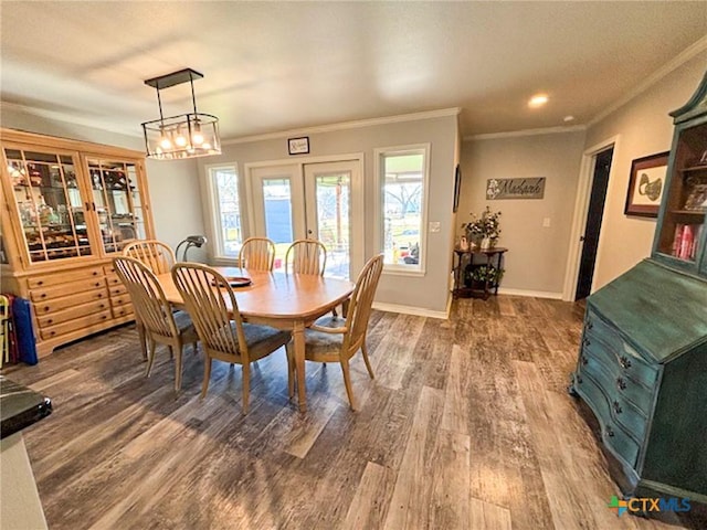 dining area with crown molding, wood-type flooring, and french doors