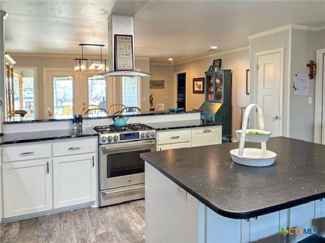 kitchen featuring white cabinetry, crown molding, stainless steel range with gas cooktop, light hardwood / wood-style floors, and exhaust hood