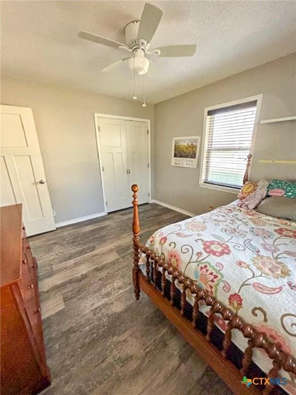 bedroom featuring ceiling fan, dark hardwood / wood-style flooring, and a textured ceiling