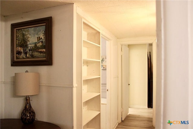 110 Crockett St, Port Lavaca, TX 77979 - hallway featuring wood finished floors and a wainscoted wall