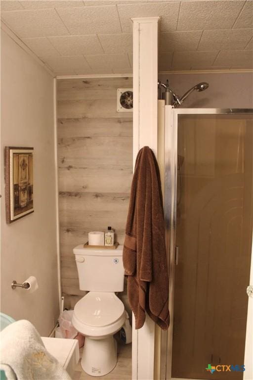 110 Crockett St, Port Lavaca, TX 77979 - full bathroom featuring a shower stall and wood walls