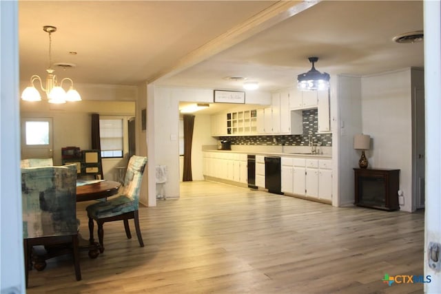 110 Crockett St, Port Lavaca, TX 77979 - kitchen featuring dishwasher, backsplash, light countertops, and light wood-style flooring