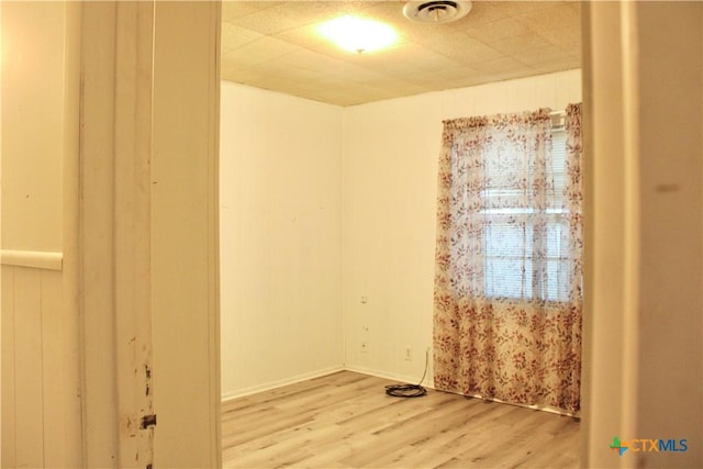 spare room with hardwood / wood-style floors