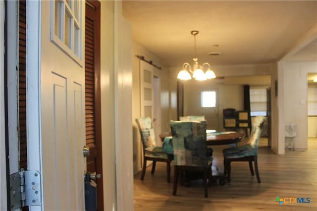 110 Crockett St, Port Lavaca, TX 77979 - dining area featuring a chandelier and wood finished floors