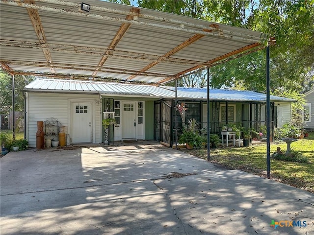 110 Crockett St, Port Lavaca, TX 77979 - view of front of house featuring a carport and a metal roof