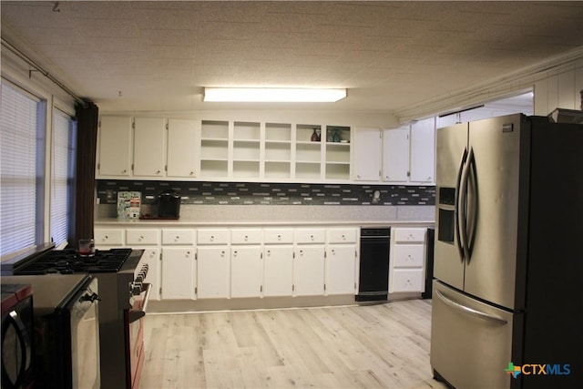 110 Crockett St, Port Lavaca, TX 77979 - kitchen featuring stainless steel refrigerator with ice dispenser, open shelves, range with gas stovetop, and white cabinetry