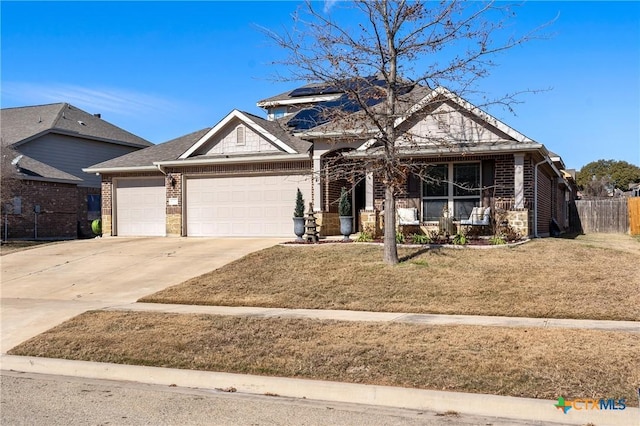 view of front of property with a porch, a front yard, and a garage