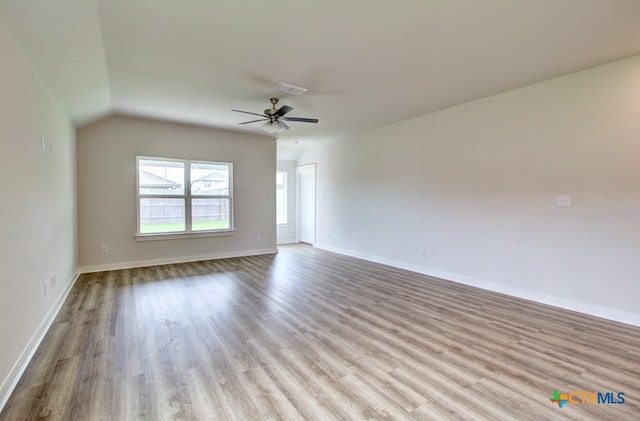 980 Gray Cloud Dr, New Braunfels, TX 78130 - empty room with wood finished floors, ceiling fan, baseboards, and lofted ceiling