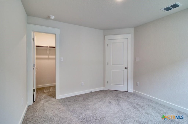 980 Gray Cloud Dr, New Braunfels, TX 78130 - unfurnished bedroom with carpet floors, a walk in closet, and baseboards