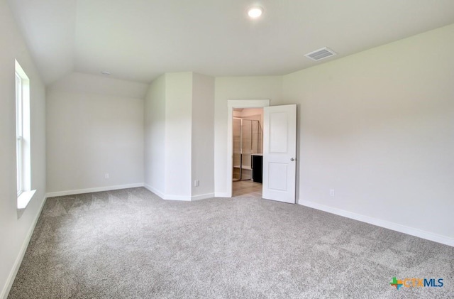 980 Gray Cloud Dr, New Braunfels, TX 78130 - unfurnished bedroom featuring carpet flooring, baseboards, lofted ceiling, and a walk in closet