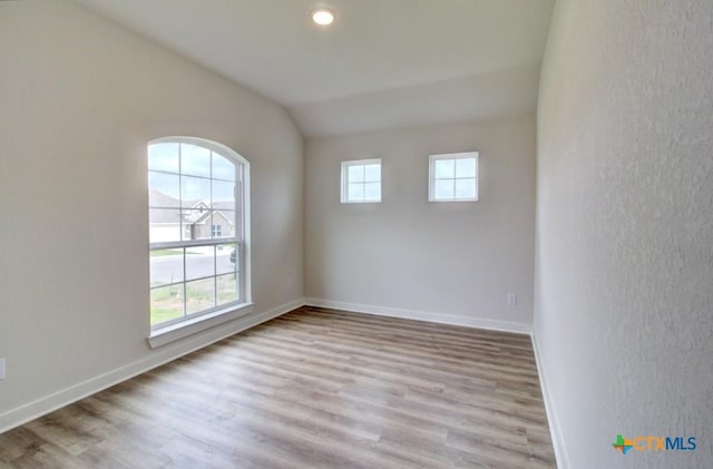 980 Gray Cloud Dr, New Braunfels, TX 78130 - spare room with wood finished floors, lofted ceiling, baseboards, and a textured wall