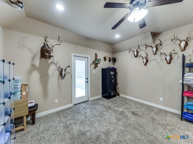 interior space featuring light carpet and ceiling fan