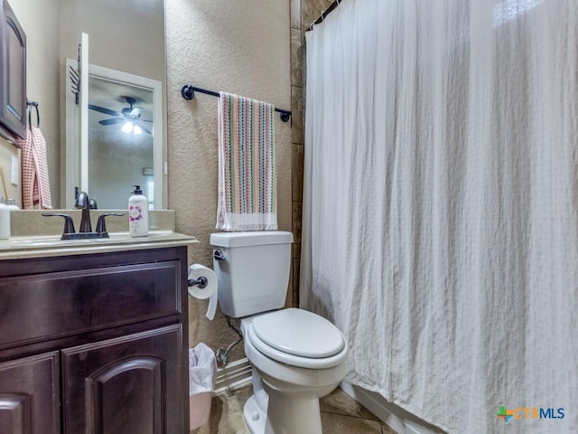 bathroom with toilet, vanity, tile patterned flooring, ceiling fan, and curtained shower