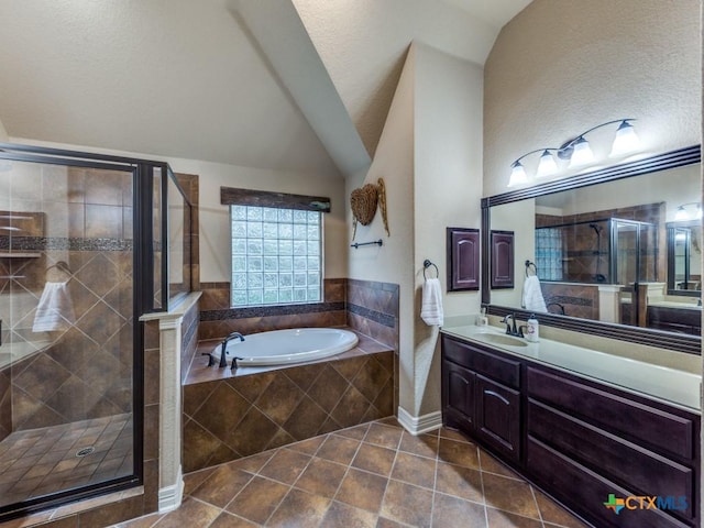 bathroom with independent shower and bath, lofted ceiling, tile patterned floors, and vanity