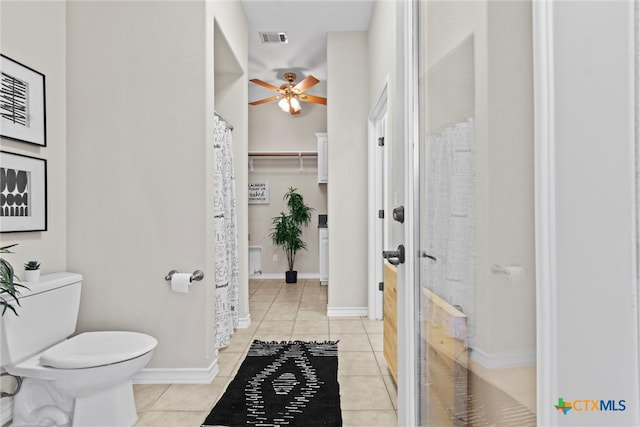 bathroom featuring toilet, ceiling fan, and tile patterned floors