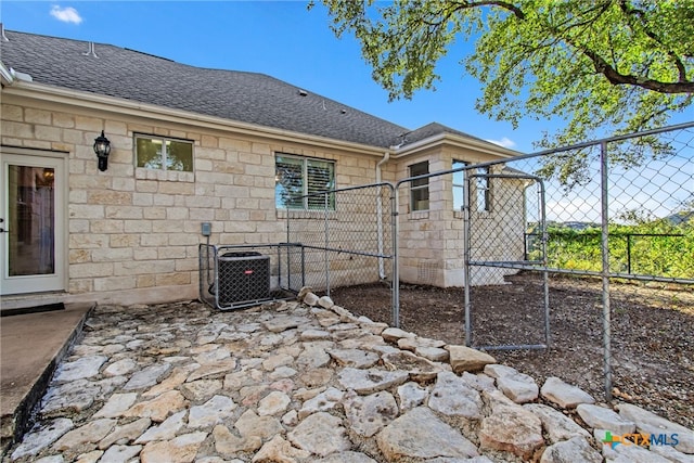 back of house featuring central air condition unit