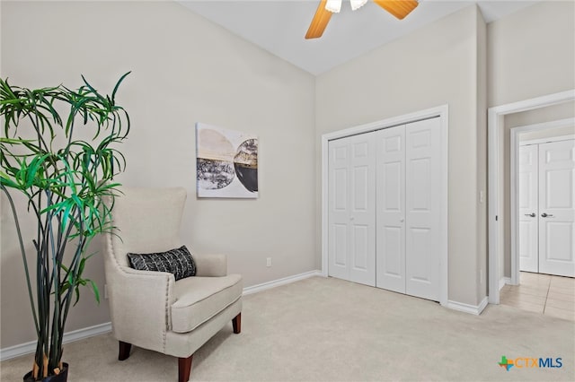 sitting room featuring ceiling fan, light colored carpet, and high vaulted ceiling