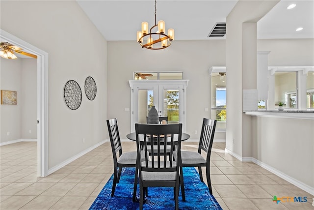 dining room with french doors, ceiling fan with notable chandelier, and light tile patterned flooring