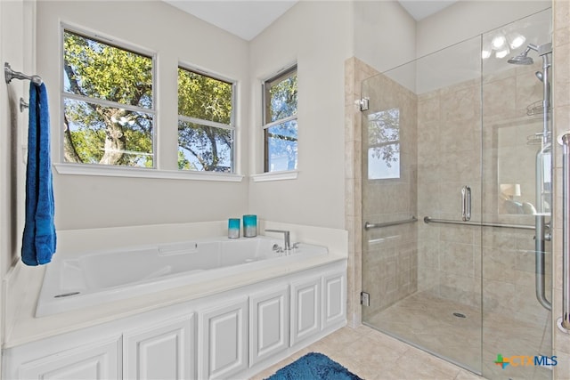 bathroom featuring tile patterned flooring and shower with separate bathtub