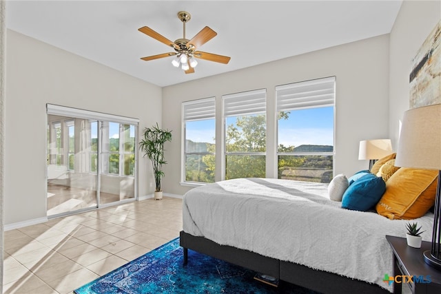 tiled bedroom with ceiling fan