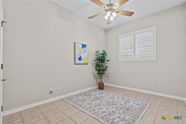 tiled empty room with ceiling fan