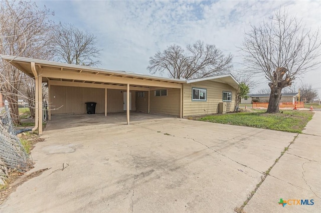 exterior space with a carport and concrete driveway