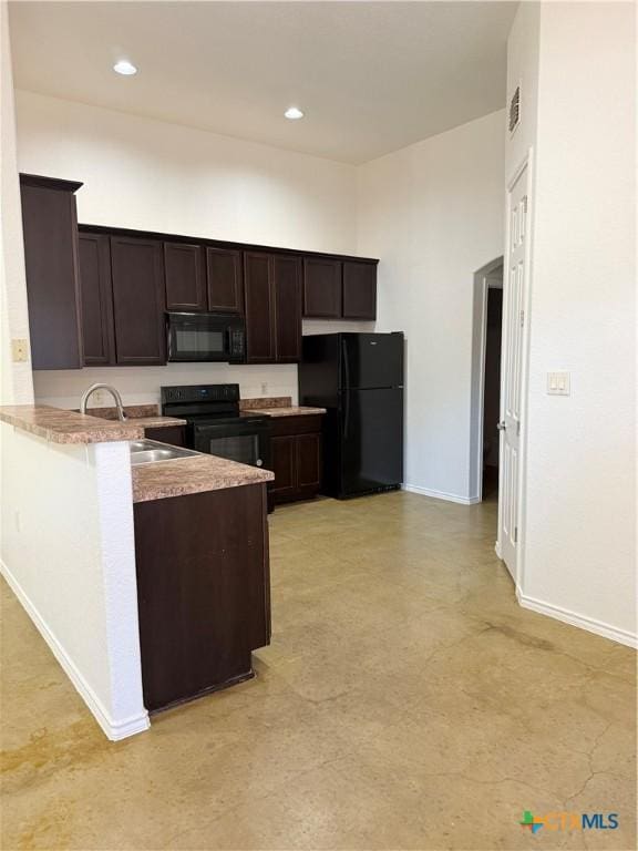 209 Anne Louise Dr, New Braunfels, TX 78130 - kitchen featuring baseboards, a peninsula, a sink, black appliances, and dark brown cabinetry