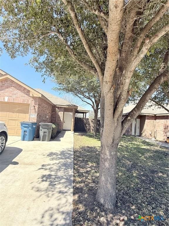 209 Anne Louise Dr, New Braunfels, TX 78130 - single story home featuring concrete driveway, an attached garage, fence, and brick siding