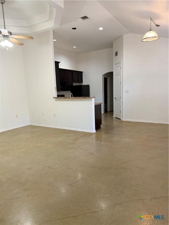 209 Anne Louise Dr, New Braunfels, TX 78130 - unfurnished living room featuring a ceiling fan, baseboards, recessed lighting, arched walkways, and finished concrete floors
