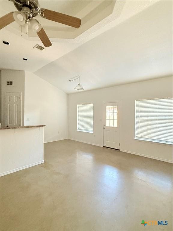 209 Anne Louise Dr, New Braunfels, TX 78130 - spare room featuring visible vents, baseboards, concrete flooring, vaulted ceiling, and a ceiling fan