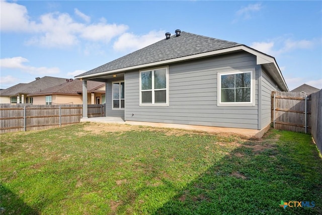 rear view of property featuring a patio and a lawn