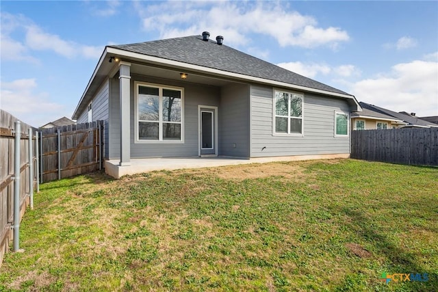 back of property featuring a lawn and a patio