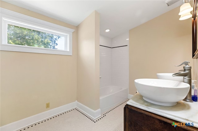 395 Dale Ln, Dale, TX 78616 - bathroom featuring baseboards, vanity, and tub / shower combination