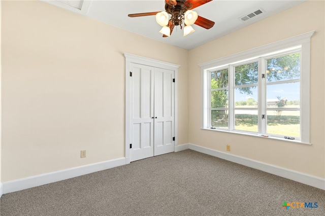 395 Dale Ln, Dale, TX 78616 - unfurnished bedroom with carpet, baseboards, multiple windows, and a closet