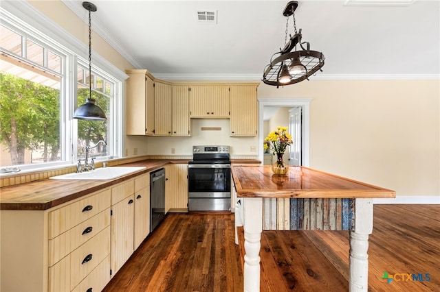 395 Dale Ln, Dale, TX 78616 - kitchen with appliances with stainless steel finishes, wood counters, cream cabinets, a sink, and dark wood-style floors