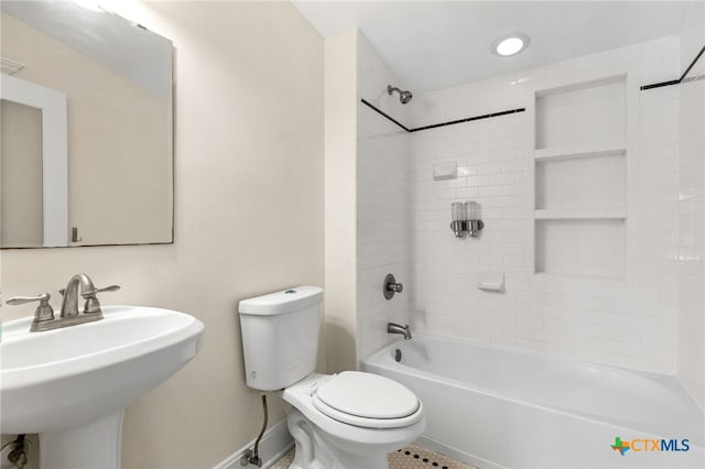 395 Dale Ln, Dale, TX 78616 - bathroom featuring a sink, toilet,  shower combination, and baseboards
