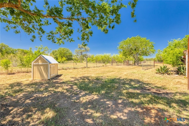 395 Dale Ln, Dale, TX 78616 - view of yard with fence, a storage shed, an outdoor structure, and a view of countryside