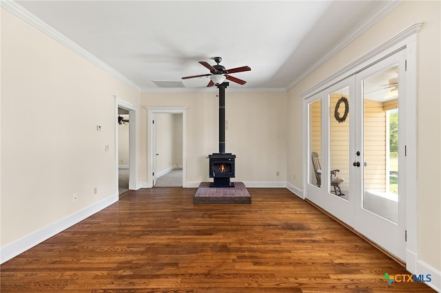 395 Dale Ln, Dale, TX 78616 - unfurnished living room with crown molding, a wood stove, wood finished floors, ceiling fan, and baseboards