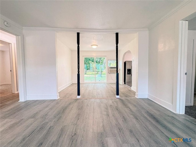 3007 Meadowlane St, Victoria, TX 77901 - unfurnished room with arched walkways, wood finished floors, baseboards, ornamental molding, and a smoke detector