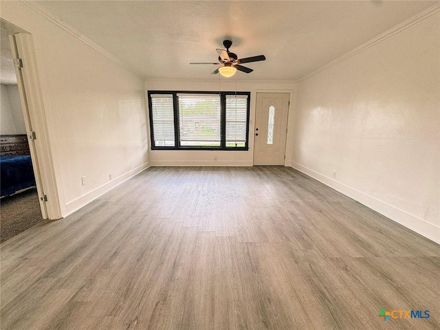 3007 Meadowlane St, Victoria, TX 77901 - unfurnished living room featuring ornamental molding, a ceiling fan, wood finished floors, and baseboards