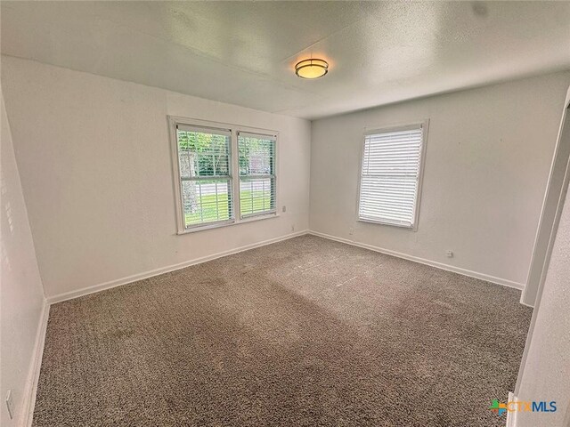 3007 Meadowlane St, Victoria, TX 77901 - carpeted empty room with baseboards