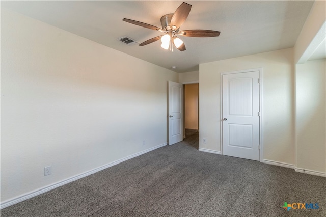 unfurnished bedroom with dark colored carpet and ceiling fan