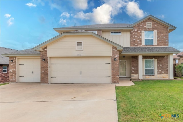 view of front of home featuring a front yard and a garage