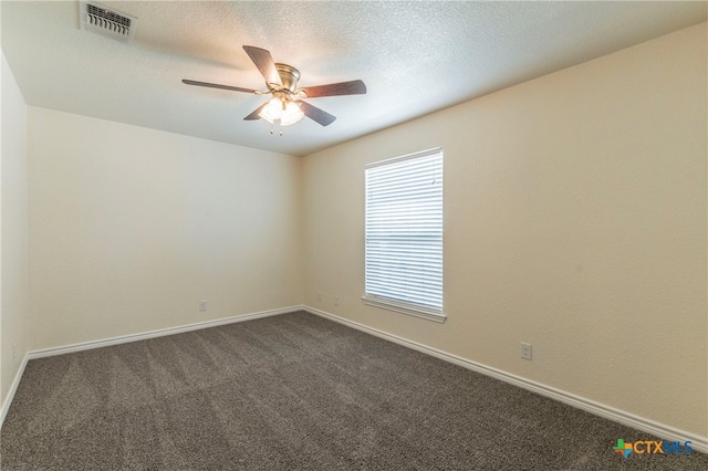 unfurnished room featuring a textured ceiling, dark colored carpet, and ceiling fan